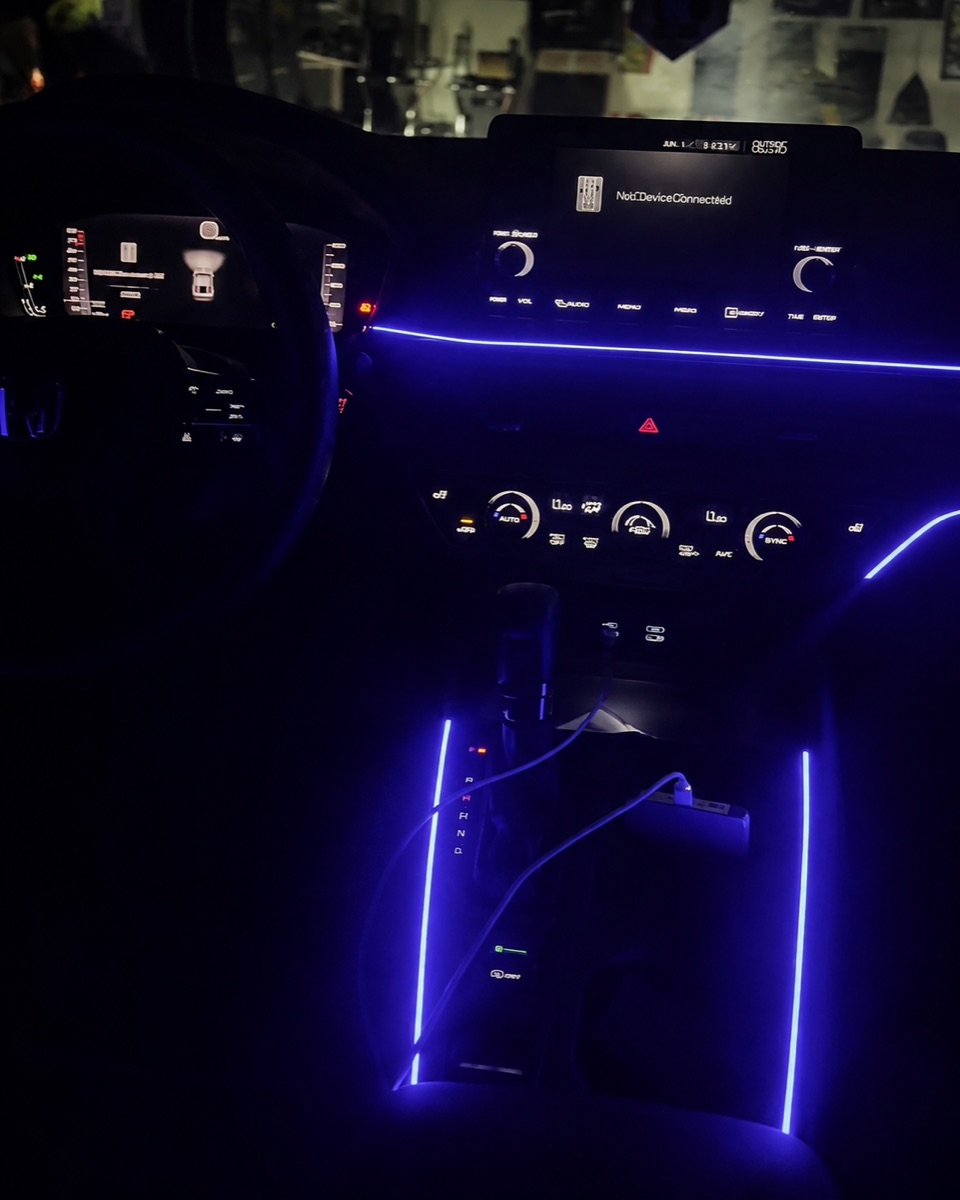Violet ambient lighting across the dashboard and center console